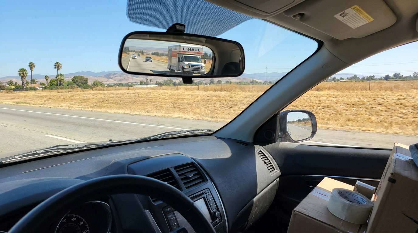 Moving truck driving on a California highway representing long-distance move preparation