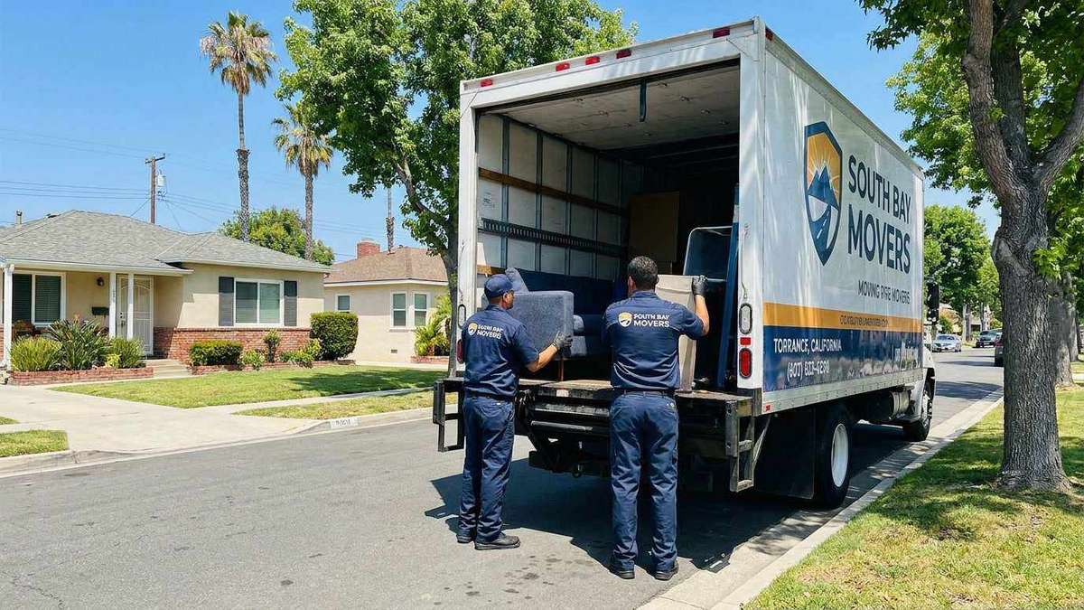 Ironmen Moving professionals in navy uniforms loading boxes on a clean residential street in Torrance, CA South Bay area